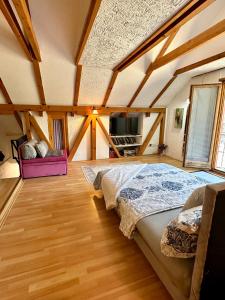 a bedroom with a large bed in a attic at Studio Palma in Zvornik