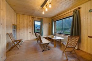 a room with a table and chairs and a window at Gorai Sauna in Kazbegi