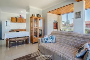 a living room with a couch and a table at Apto 2 Quartos a 260m da Praia RIB0201 in Barra de Ibiraquera