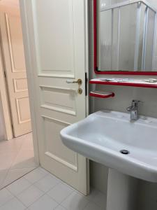 a bathroom with a white sink and a mirror at Sole Mare da Tina in Cittadella del Capo +28 photos