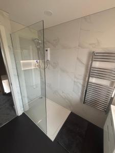a shower with a glass door in a bathroom at 25 Colliers Road,Stirling in Plean Station +9 photos