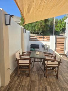 a patio with a table and chairs on a deck at La Casa di Levante in Zakynthos