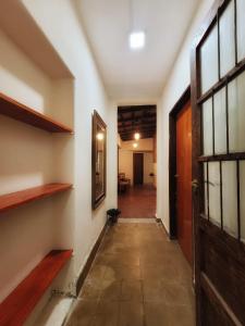 an empty hallway with a door and a room at Cómo en casa, cerca de todo, amplio 100m2 in San Miguel de Tucumán