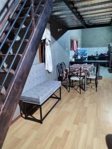 a living room with a table and chairs and a staircase at Casa de campo San Marcos in Pujilí +20 photos