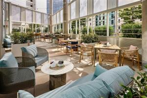 a large room with tables and chairs and windows at Courtyard by Marriott Berlin City Center in Berlin