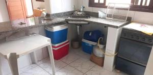 a kitchen with a sink and a counter top at Acomodação Santana in Serrinha