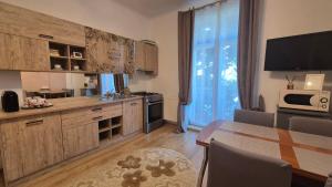 a kitchen with a table and a dining room at Park Residence in Bacău