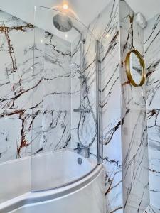 a bathroom with a shower and a tub at Comfy private room in shared house in Cambridge