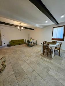 a living room with a couch and a table and chairs at Ca' San Valentino in Pontelongo