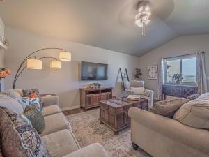a living room with two couches and a tv at Isaac's Nook in the Hills in Rapid City