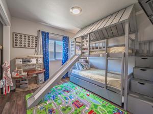 a childs bedroom with bunk beds and a train crib at Isaac's Nook in the Hills in Rapid City