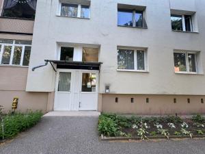 a building with a white door and windows at Zora Apartman in Veszprém