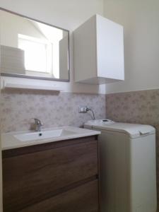 a bathroom with a sink and a mirror at Appartamento Aurora Pro in Altamura