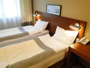 Postel nebo postele na pokoji v ubytování Hotel Atrium