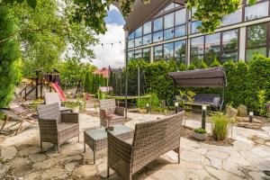a patio with chairs and a table and a building at Rezydencja Wind Rose Luxury ApartHotel Gdańsk - Prywatne SPA in Gdańsk