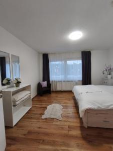 a bedroom with a large bed and a wooden floor at FeWo im Harz Bad Harzburg in Bad Harzburg