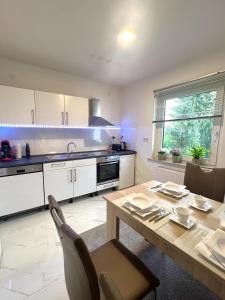 a kitchen with a wooden table and a dining room at FeWo im Harz Bad Harzburg in Bad Harzburg