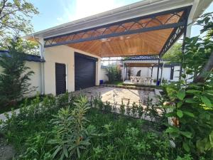 an outdoor patio with a wooden pergola at Luxury villa Gabala ELM in Gabala