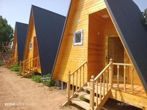 a row of cottages in a row at Azamat Guest House in Bokonbayevo