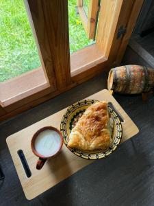 a table with a plate of food and a cup of milk at Vintage House in Elena