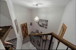a hallway with a staircase with a chandelier at Casa Paulina in Guanajuato