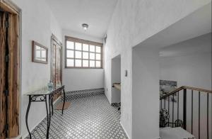 an empty hallway with a table and a window at Casa Paulina in Guanajuato +1 photo