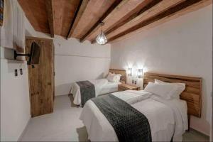 a bedroom with two beds in a room at Casa Paulina in Guanajuato