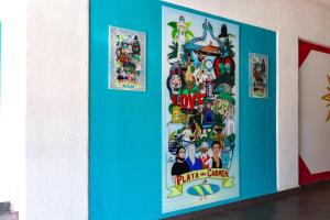a blue wall with posters on it at Hotel MX portal maya in Playa del Carmen