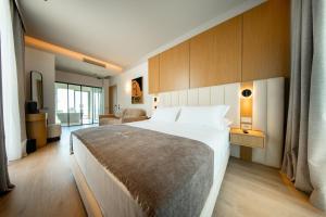 a bedroom with a large bed and a living room at Saint Nicolas Hotel in Himare +69 photos