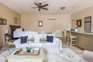 a living room with a couch and a table at Cozy Sedona Casita with Private Courtyard & Stargazing Hot Tub in Sedona