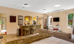 a living room with a couch and a bar at Cozy Sedona Casita with Private Courtyard & Stargazing Hot Tub in Sedona