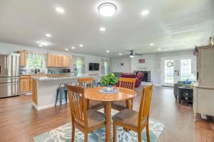 a kitchen and living room with a table and chairs at Walk to Marina and Lake Family Retreat in Afton! in Afton