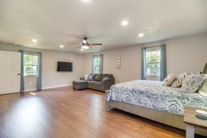 a bedroom with a bed and a couch and a tv at Walk to Marina and Lake Family Retreat in Afton! in Afton