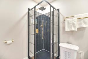 a glass shower in a bathroom with a toilet at Walk to Marina and Lake Family Retreat in Afton! in Afton +29 photos