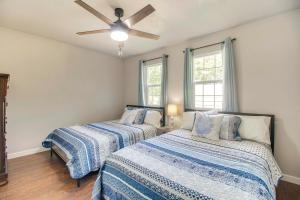 a bedroom with two beds and a ceiling fan at Walk to Marina and Lake Family Retreat in Afton! in Afton