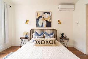 a bedroom with a large bed with blue pillows at Stay Portland - 2BR Flat - Walk to NW 23rd Shops & Cafes in Portland