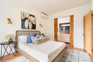 a bedroom with a large bed with blue pillows at Stay Portland - 2BR Flat - Walk to NW 23rd Shops & Cafes in Portland