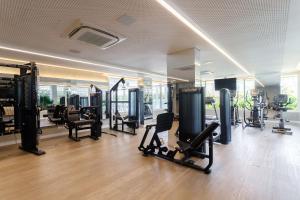 a gym with many exercise equipment in a room at Apto 2 Quartos com Sacada Ed.Jardim Milano in Florianópolis