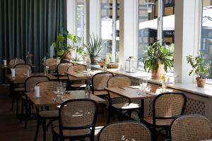 a row of tables and chairs in a restaurant at Hotel Saxkjøbing in Sakskøbing