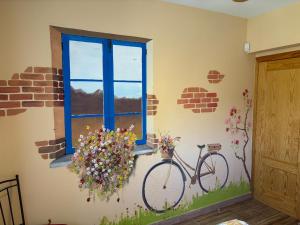 a room with a bike on the wall with a window at Casa Rural El Fresno in Burgohondo +29 photos