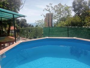 a large blue swimming pool in a backyard at Studio à deux pas de Monaco in Roquebrune-Cap-Martin