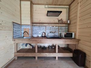 a wooden counter in a kitchen in a wooden cabin at Carpathian House in Krasnik