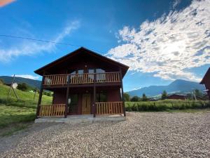 a small building with a porch and a balcony at Carpathian House in Krasnik