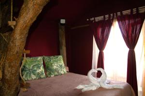 a bedroom with a bed with two swans on it at El Refugio de Las Vegas in Valsequillo +15 photos