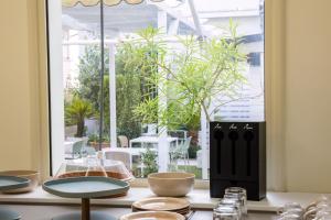 a table with bowls and glasses on a window at Dimora Don Ciccillo B&B in Bagnara Calabra