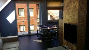 TV a/nebo společenská místnost v ubytování Apartament Lisi Jar Jastrzębia Góra Widok 4