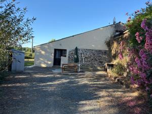 a white building with a bench in front of it at Grange in Saint-Paul-Mont-Penit