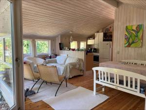 a kitchen and a living room with a table and chairs at 90714-Bogo-By-Hojdedraget-56 in Bogø By