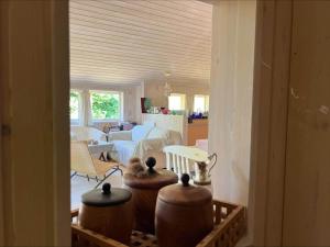 a living room with vases and a living room with a couch at 90714-Bogo-By-Hojdedraget-56 in Bogø By