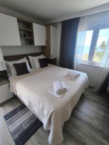 a bedroom with a large bed with towels on it at Skyrock in Tučepi